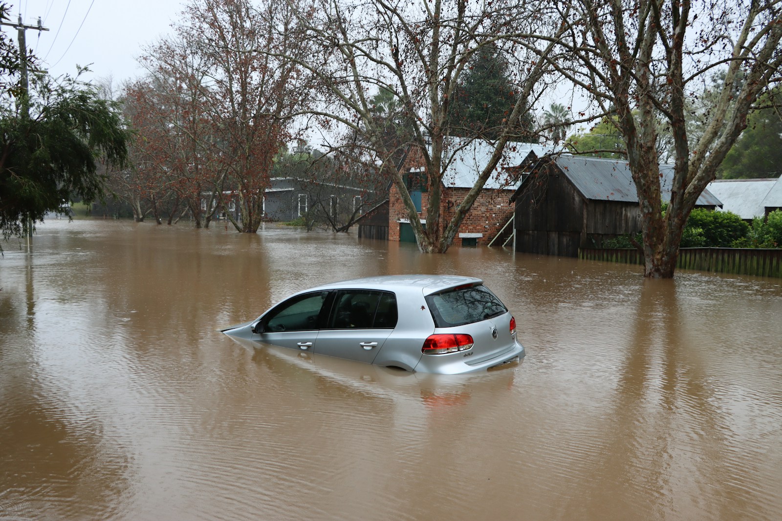 a car driving through a flooded street, flood
